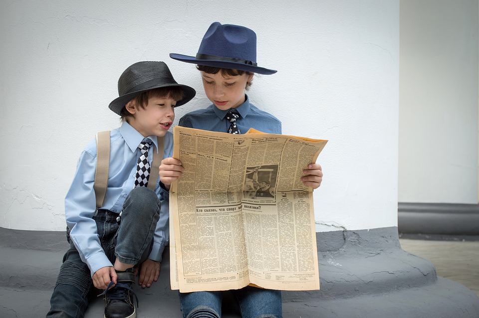 Vorlesen einer Zeitung von Kind zu Kind